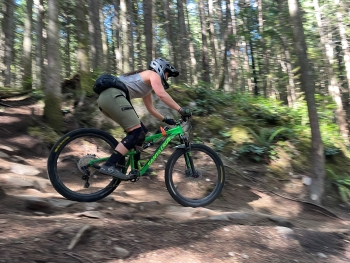 Mountain biker riding down rocky trail